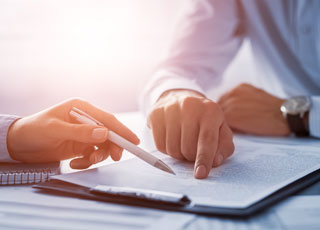 Two People Reviewing a Document Two People Reviewing a Document